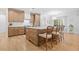 Bright kitchen with hardwood floors, kitchen island, and stainless steel appliances at 200 Whispering Pines Dr, Woodstock, GA 30188