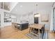 Open kitchen and dining area with a large island, modern appliances, and dining table at 200 Whispering Pines Dr, Woodstock, GA 30188