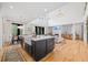 Open-concept kitchen and living room offering modern design, natural light, and hardwood floors at 200 Whispering Pines Dr, Woodstock, GA 30188