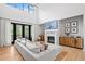 Cozy living room showcasing a fireplace, hardwood floors, and access to outdoor living at 200 Whispering Pines Dr, Woodstock, GA 30188