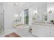 Bright main bathroom with a freestanding tub, dual vanities, and elegant fixtures at 200 Whispering Pines Dr, Woodstock, GA 30188