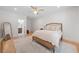 Bright main bedroom with a ceiling fan, rug, wood floors, and ensuite bathroom at 200 Whispering Pines Dr, Woodstock, GA 30188
