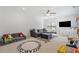 Spacious playroom with a comfortable sectional sofa and a fun alphabet rug at 200 Whispering Pines Dr, Woodstock, GA 30188