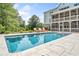Rear exterior featuring a swimming pool and spa, a covered deck, and outdoor lounge furniture at 200 Whispering Pines Dr, Woodstock, GA 30188