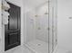 Modern walk-in shower with glass enclosure, dual shower heads, and stylish tile work at 200 Whispering Pines Dr, Woodstock, GA 30188
