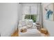 Cozy sitting area with comfortable armchair, natural light, and stylish decor at 200 Whispering Pines Dr, Woodstock, GA 30188