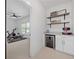 Wet bar area includes beverage refrigerator, countertop, display shelves and recessed lights at 200 Whispering Pines Dr, Woodstock, GA 30188