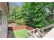 Fenced backyard overlooking a lush, tree-lined lot that offers additional privacy at 2430 Hemrick Rd, Cumming, GA 30041