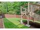 Spacious backyard featuring a green lawn, wooden fence, and an elevated deck with stairs at 2430 Hemrick Rd, Cumming, GA 30041