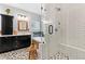Bathroom boasts double vanity, wood framed mirrors and cabinet, plus picture window above a soaking tub at 2430 Hemrick Rd, Cumming, GA 30041