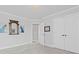 Bright bedroom featuring neutral walls, plush carpet, and closet with decorative mirror and accent art at 2430 Hemrick Rd, Cumming, GA 30041