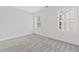 Light-filled bedroom with a neutral palette, two windows with shutter, and plush carpet flooring at 2430 Hemrick Rd, Cumming, GA 30041