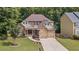 Beautiful stone and siding home with a two-car garage and well-manicured lawn at 2430 Hemrick Rd, Cumming, GA 30041