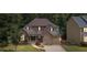 Charming two-story home with a stone facade, a well-manicured lawn, and a two-car garage at 2430 Hemrick Rd, Cumming, GA 30041