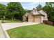 Lovely home with a spacious driveway, two-car garage, and lush green lawn at 2430 Hemrick Rd, Cumming, GA 30041