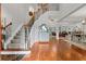 Elegant foyer with hardwood floors, a staircase with wood railing, and an open floor plan at 2430 Hemrick Rd, Cumming, GA 30041