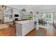 Open kitchen with island, dining area, and hardwood floors overlooking living area at 2430 Hemrick Rd, Cumming, GA 30041