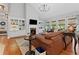 Spacious living room with a fireplace, built-in bookshelves, hardwood floors, and large windows at 2430 Hemrick Rd, Cumming, GA 30041