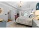 Well-lit main bedroom with a tray ceiling, neutral color palette, and elegant furnishings at 2430 Hemrick Rd, Cumming, GA 30041