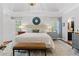 Spacious main bedroom featuring trey ceilings, neutral paint, wood floors, and lots of natural light at 2430 Hemrick Rd, Cumming, GA 30041