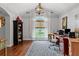 Spacious home office with vaulted ceilings, hardwood floors, large windows and a decorative chandelier at 2430 Hemrick Rd, Cumming, GA 30041