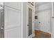 Hallway featuring large pantry with decorative glass door and hardwood floors at 2430 Hemrick Rd, Cumming, GA 30041