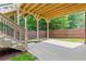 Patio with stairs leading to deck overlooking lush green backyard at 2430 Hemrick Rd, Cumming, GA 30041