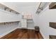 Organized walk-in closet with built-in shelves, hanging rods, and ample storage space at 2430 Hemrick Rd, Cumming, GA 30041