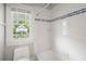 Bright bathroom with white tile, tub with shower, and window offering outside views at 315 Melrose Ave, Decatur, GA 30030