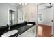 Bathroom features a dual sink vanity with black countertops and white cabinets at 315 Melrose Ave, Decatur, GA 30030