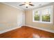 Cozy bedroom with hardwood floors, a ceiling fan, and a large window view at 315 Melrose Ave, Decatur, GA 30030