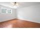A simple bedroom showcasing hardwood floors, a ceiling fan, and a sunlit window at 315 Melrose Ave, Decatur, GA 30030