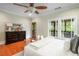 Comfortable bedroom with hardwood floors, a ceiling fan, and a private balcony entrance at 315 Melrose Ave, Decatur, GA 30030