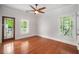 Bright bedroom with hardwood floors, ceiling fan, and natural light from windows and glass door at 315 Melrose Ave, Decatur, GA 30030