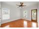 Bright bedroom featuring hardwood floors, ceiling fan, and natural light from windows and glass door at 315 Melrose Ave, Decatur, GA 30030