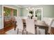 Elegant dining room with a wooden table, chandelier, and large windows at 315 Melrose Ave, Decatur, GA 30030
