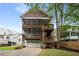 Charming home featuring double porches with wooden railings, two-car garage, and well-maintained lawn at 315 Melrose Ave, Decatur, GA 30030