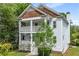 Attractive two-story home with a double porch, complemented by lush greenery and mature trees at 315 Melrose Ave, Decatur, GA 30030