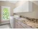Well-lit laundry room with sink, counter space, and washer/dryer at 315 Melrose Ave, Decatur, GA 30030