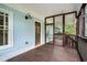Inviting screened porch with wood floors and blue siding, perfect for relaxing and enjoying the outdoors at 315 Melrose Ave, Decatur, GA 30030