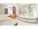 Bright bathroom with a soaking tub set in a bay window and double sink vanity at 3741 Bays Ferry Way, Marietta, GA 30062
