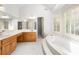 Bright bathroom featuring a soaking tub, a double sink vanity, and white marble floors at 3741 Bays Ferry Way, Marietta, GA 30062