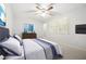 Comfortable staged bedroom with a ceiling fan, a large window, and light-colored walls at 3741 Bays Ferry Way, Marietta, GA 30062