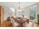 Bright dining room with hardwood floors, large windows, classic chandelier and a staircase visible at 3741 Bays Ferry Way, Marietta, GA 30062