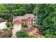 Elegant brick home nestled among trees with a well manicured lawn and a two car garage at 3741 Bays Ferry Way, Marietta, GA 30062