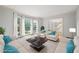 Bright living room with large windows, stylish sofas, and neutral carpet, creating an inviting atmosphere at 3741 Bays Ferry Way, Marietta, GA 30062