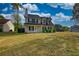 Inviting two-story home featuring a classic design and a spacious front lawn at 1700 Conductor Ln, Conyers, GA 30013