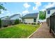 Well-maintained backyard with lush green lawn, manicured landscaping, and a private fenced perimeter at 2305 Keenland Ct, Cumming, GA 30040
