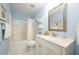 Bright bathroom featuring a tub-shower, vanity with solid countertop, and coordinated decor at 2305 Keenland Ct, Cumming, GA 30040