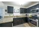 Well-equipped kitchen with granite countertops, stainless steel appliances, and ample cabinet space at 2305 Keenland Ct, Cumming, GA 30040